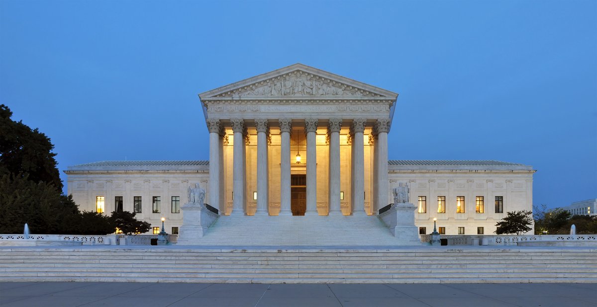 The west facade of the U.S. Supreme Court building illuminated at dusk