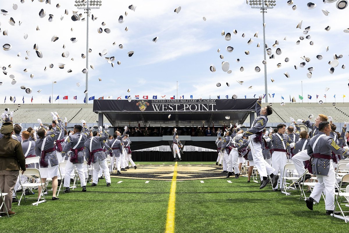Newly commissioned West Point graduates toss their hats into the air at the 2024 graduation ceremony in Michie Stadium